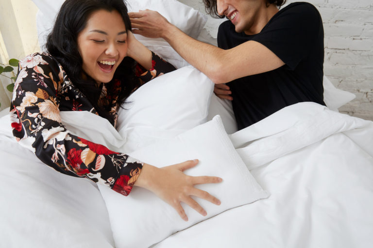 couple smiling in bed