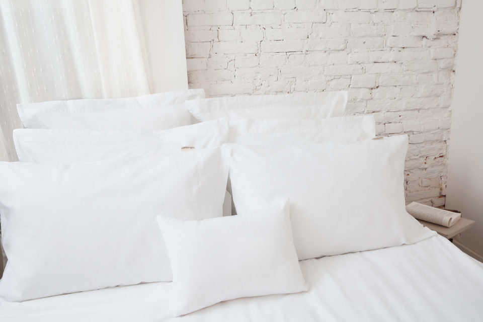 white pillows and sheets on bed
