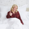 woman in bed with thumbs up